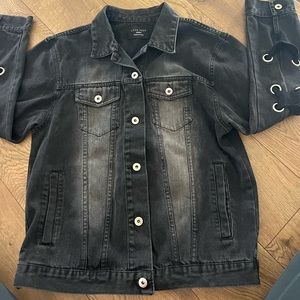 Black denim jacket with lace up feature along arms and back